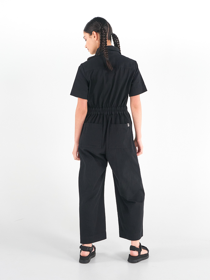 Back view of Stella Jumpsuit in Liquorice black cotton, relaxed workwear fit, Sydney design.