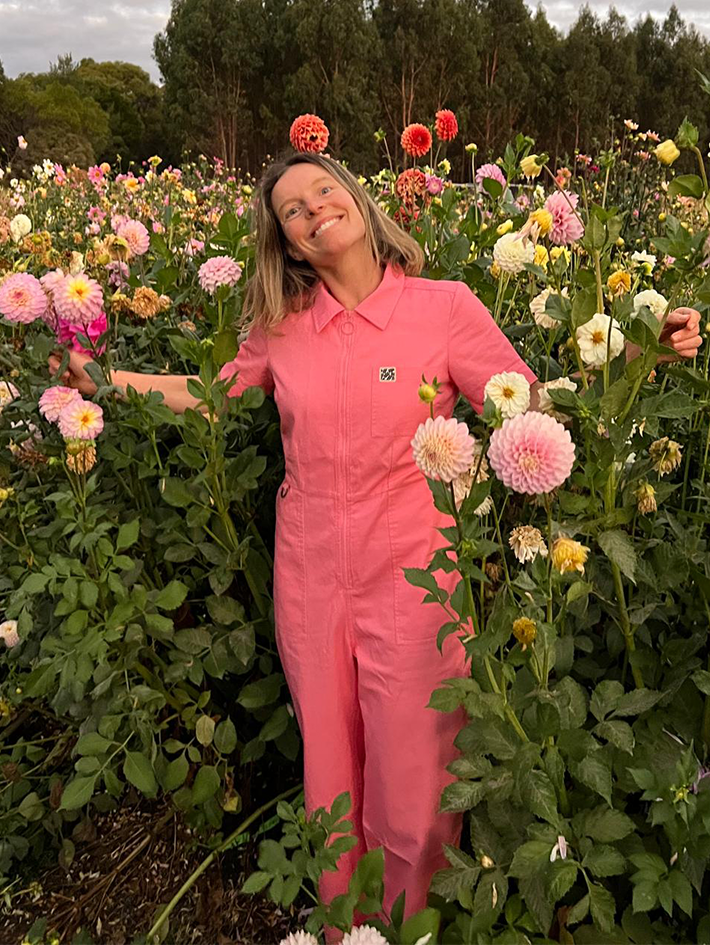 Flower farmer wearing the Stella Jumpsuit in Bubblegum Pink by Madge Goods